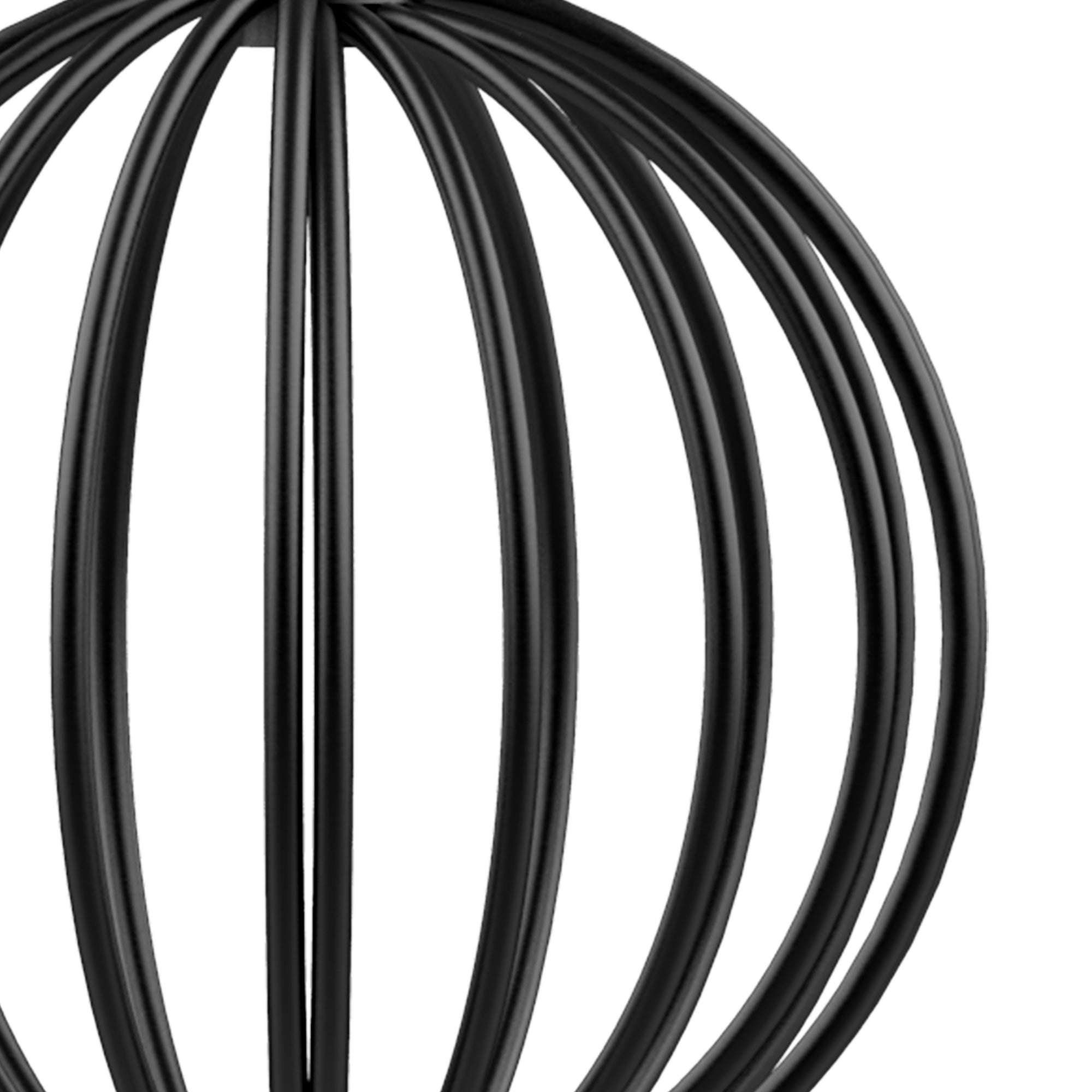 Close-up of black metal wire sculpture on restraint cage